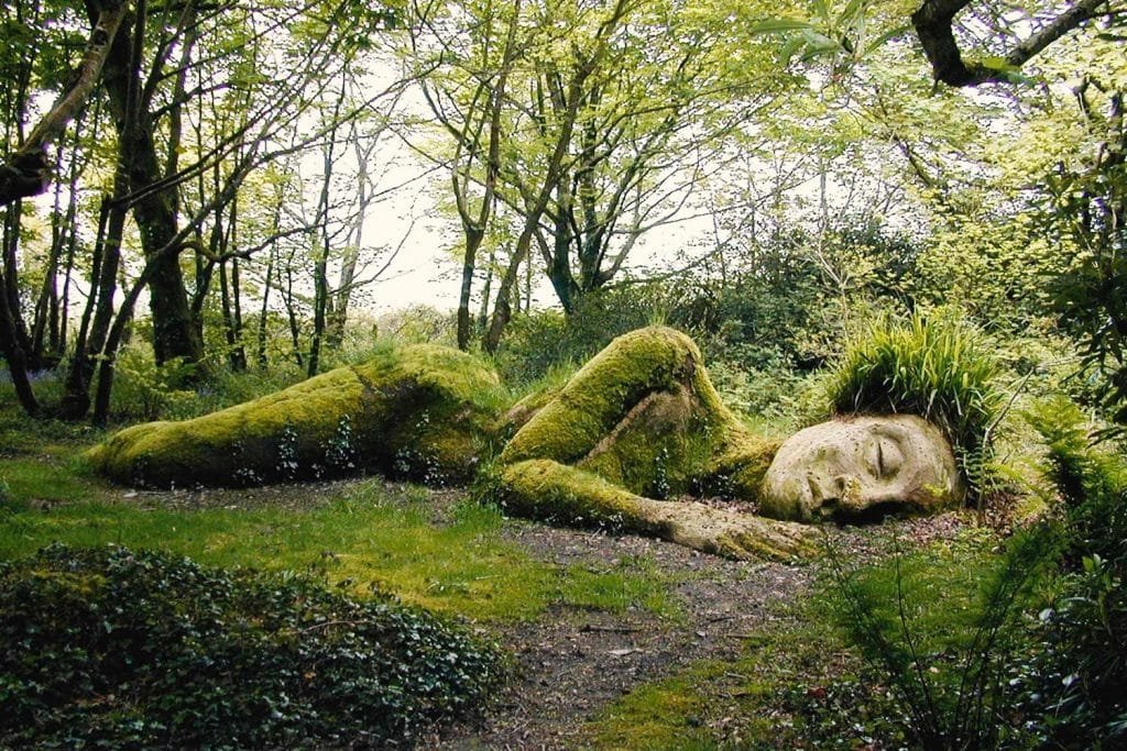The Mud Maid at Heligan, a grassy statue lying down