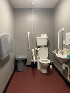 Accessible toilet, well lit with grab rails 