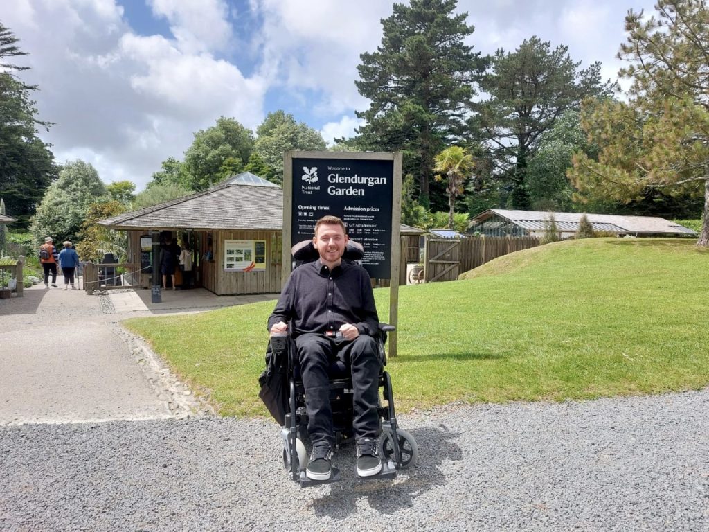 Ross in his wheelchair outside the entrance to Glendurgan Gardens