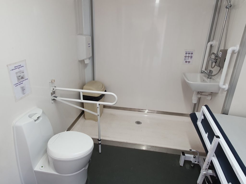 The portable unit has a platform lift into the unit and inside is equipped with a full size adult changing table, shower 