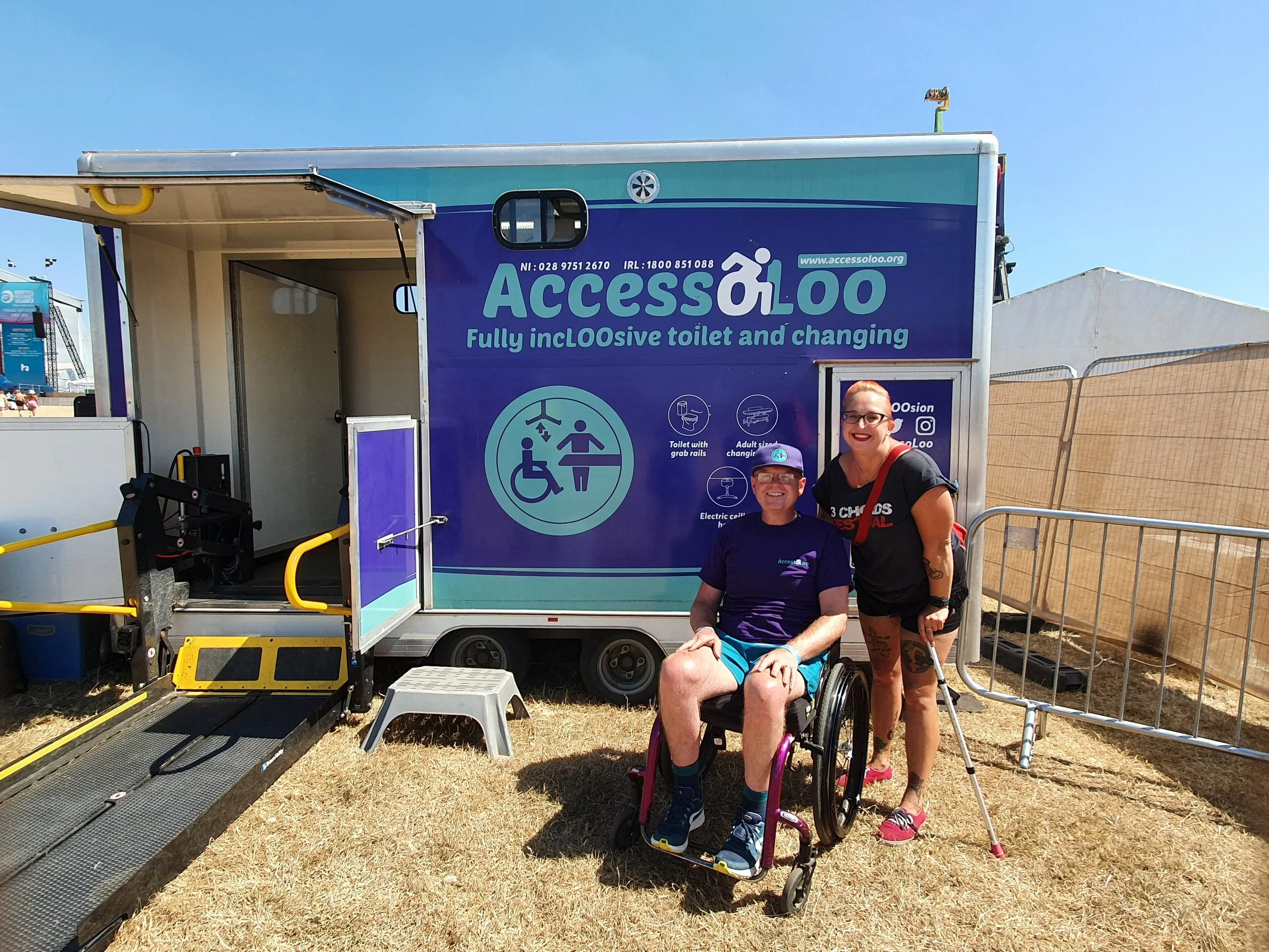 outside of The AccessoLoo. its founder Michael Holden smiling with our reviewer Ally