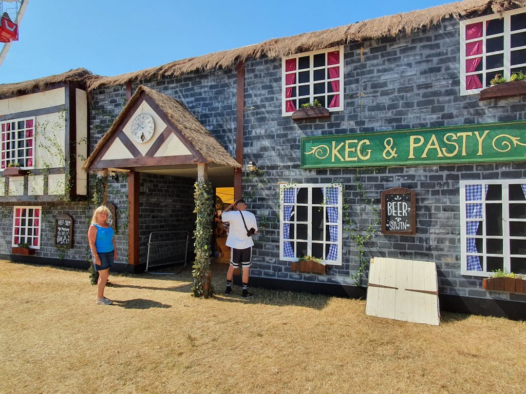 Mary Ouside the Keg and Pasty stage. Decor is modeld on an old Tudor pub, fake thatch roof, wooden beams, climbing vines and grey false brick