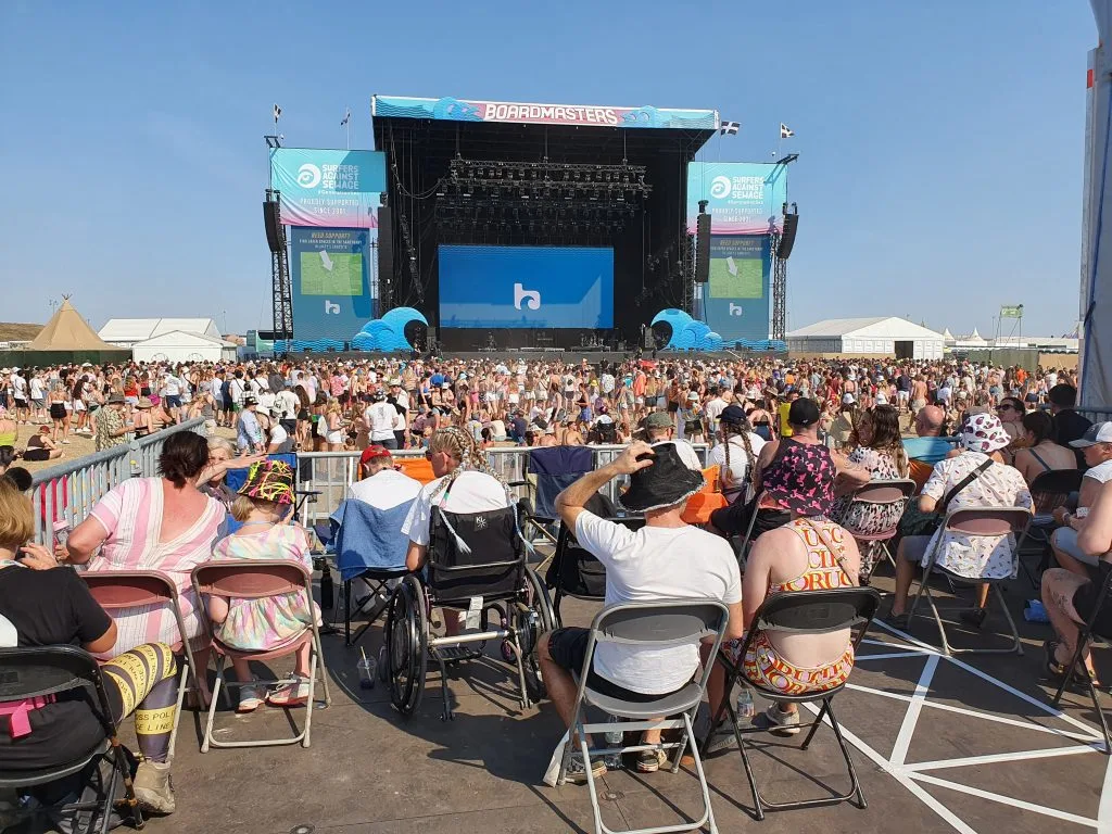 The Access Platform with 20 or so people on it, the ground in front of the main stage is filling up