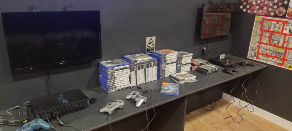 Part of the gaming area showing a playstation two and a nintendo 64 with lots of games