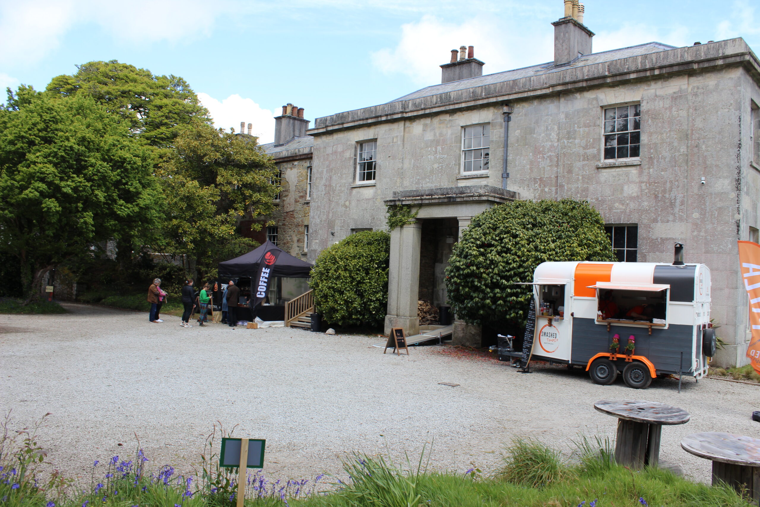 The woodfired pizza van and coffee and cake stall by Enys House at the Bluebell Festival