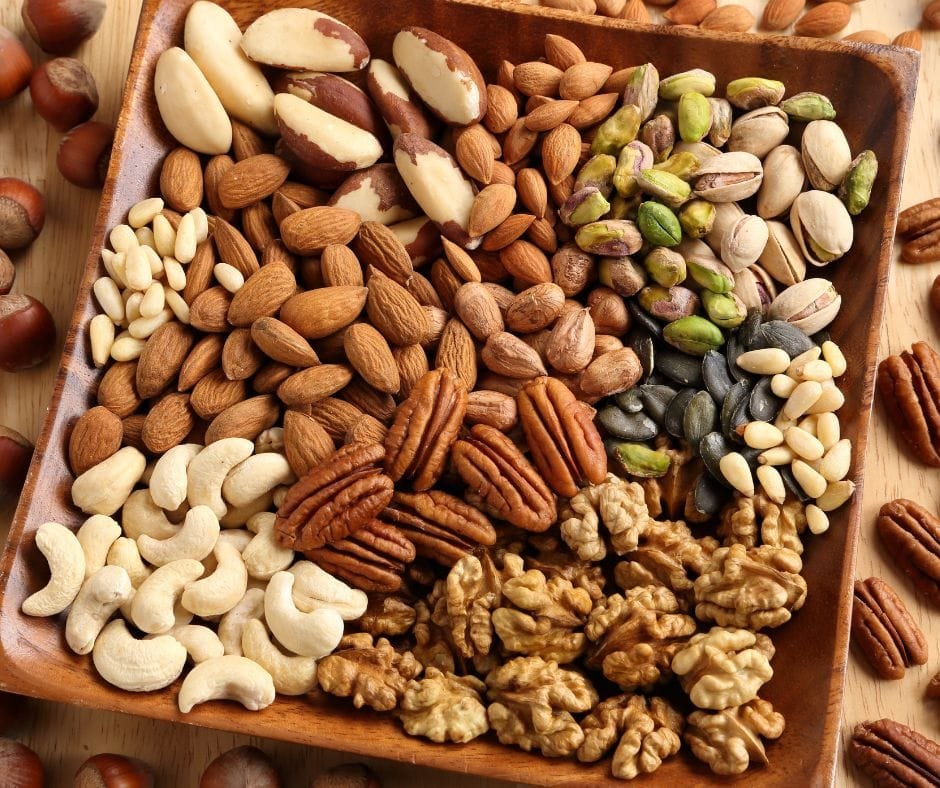 A square bowl filled with different types of nuts
