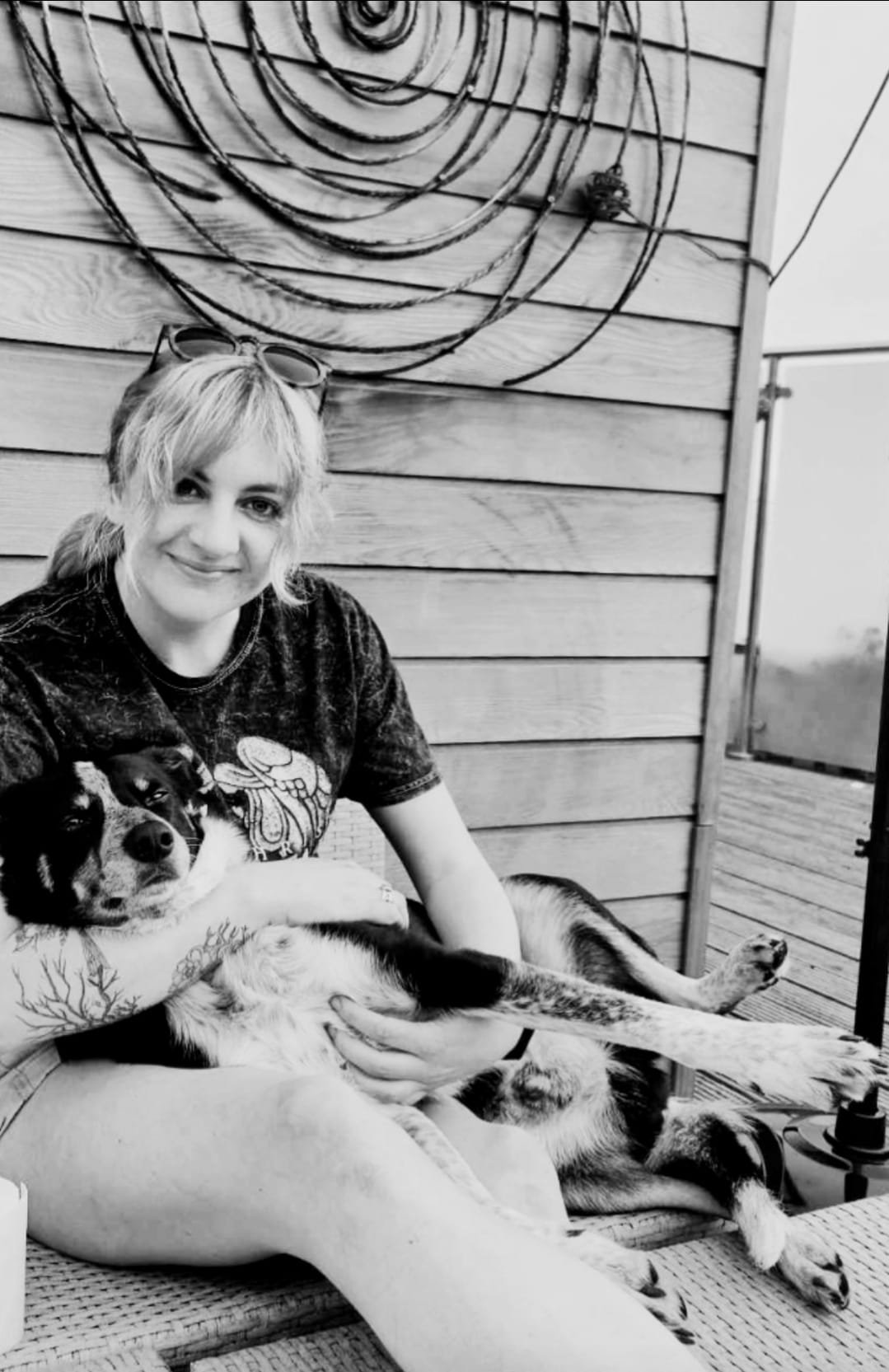 Becky, sat cuddling her Border Collie