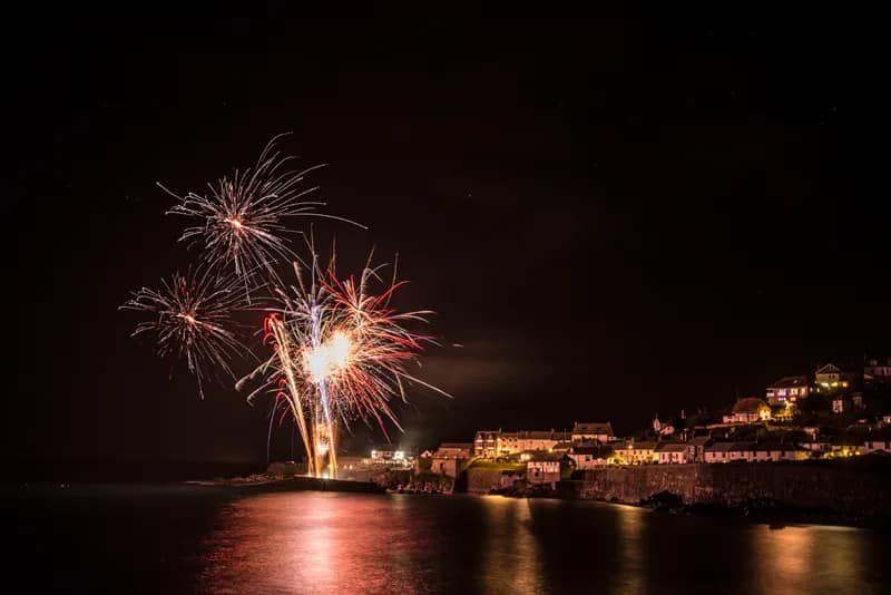 Fireworks filling the night sky over Coverack Harbour in 2024
